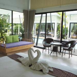 a swan sitting on the floor of a living room at Jasmine Resort And Spa in Khanom