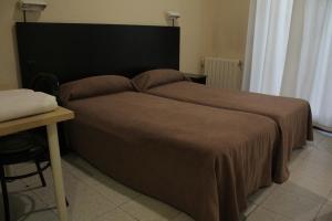 
Кровать или кровати в номере Hostal Baires
