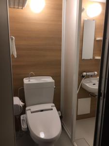 福岡市にあるホテル CASVI TENJINのバスルーム(白いトイレ、シンク付)