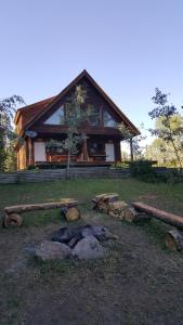 a log cabin with a fire in front of it at Wettstone Guest Ranch in Bridge Lake