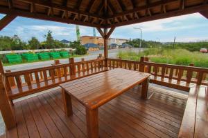 a wooden porch with a wooden table on a deck at Long Xing B&B in Huxi