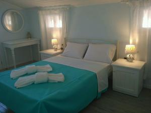 a bedroom with a bed with two towels on it at Sofia-Irini in Kalamaki Heraklion