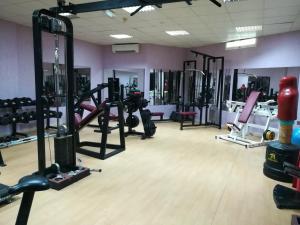 a gym with a bunch of equipment in a room at Safari Hotel in Nizwa
