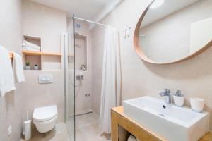 a bathroom with a sink and a toilet and a mirror at Fenice Palace in Šibenik