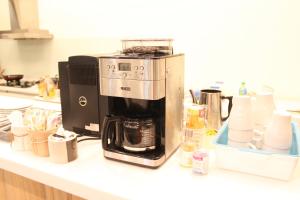 a coffee maker sitting on top of a counter at Long Xing B&B in Huxi