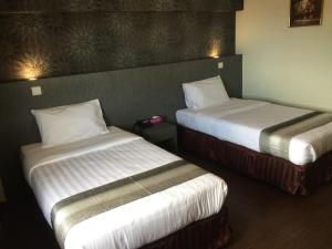 Postel nebo postele na pokoji v ubytování Check Inn Hotel Tawau