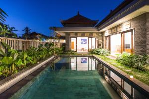a swimming pool in the backyard of a house at Laba Ubud Villa in Ubud