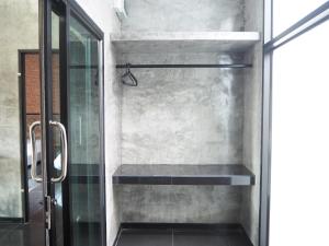 a shower with a glass door in a bathroom at Needa Rock Resort in Khanom