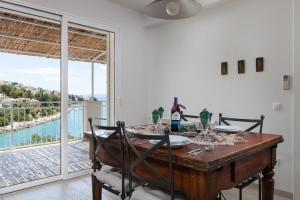 a dining room with a table and a view of the water at Holiday home Duje in Trogir