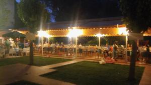 a group of people sitting at a restaurant at night at Nefeli Hotel in Kozani