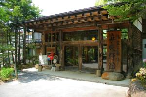 a small building with an entrance with a gate at Shibu Tatunokan in Chino