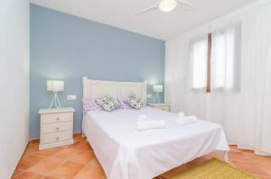 a bedroom with a white bed with two towels on it at Sa Caseta De Ses Vaques. Son Covas (Sa Vaqueria 2) in Campos +28 photos
