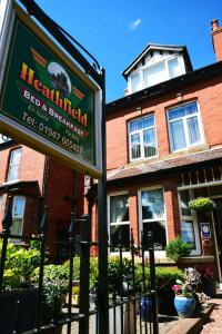 a sign for a restaurant in front of a building at Heathfield Bed and Breakfast in Whitby