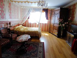 a bedroom with a bed and a couch and a window at Agroturystyka Zacisze in Osowia
