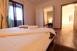 a bedroom with a large bed and a large window at Danica in Smoljanci +24 photos