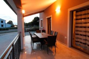 a table and chairs on the balcony of a house at Danica in Smoljanci