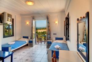 a hotel room with two beds and a balcony at Villa Marita in Lisvórion