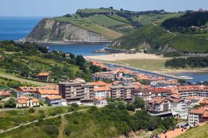 a town on a hill next to a body of water at Hotel Flysch in Zumaia