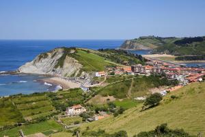 a small town on a hill next to the ocean at Hotel Flysch in Zumaia