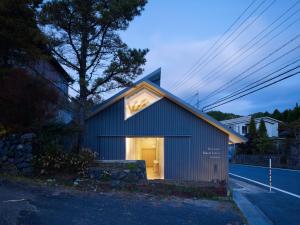 a blue house with a window on the side of it at Koyasan Guesthouse Kokuu in Koyasan