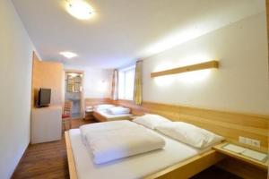 a bedroom with a large white bed in a room at Apart Muntane in Ischgl +53 photos