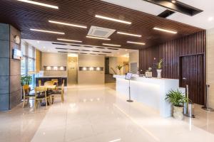 an office lobby with a reception desk and tables at Amoureux Resort in Jeju