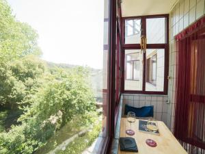 a balcony with a table with wine glasses on it at OPORTO GUEST Vila do Conde River & Sea in Vila do Conde