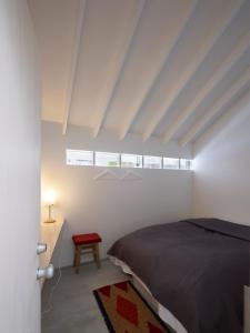 a bedroom with a bed and a table and a window at Koyasan Guesthouse Kokuu in Koyasan