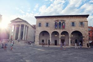 a group of people standing in front of a building at Lavender - City Room with free parking in Pula
