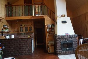 a kitchen with a fireplace and a stove in a room at Dom Pilchy nad jeziorem Roś in Pilchy