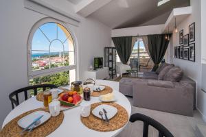 a kitchen and living room with a table and chairs at Franko & Ana apartments in Krk