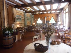 a dining room with tables and chairs and windows at Les Agneaux in Villar-dʼArène +23 photos