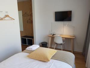 a bedroom with a bed and a desk with a computer at Hemma rooms by IKEA in Zbąszyń