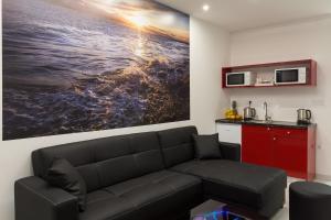 a living room with a couch and a painting on the wall at Hostel Free Bird in Dubrovnik