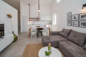 a living room with a couch and a table at Franko & Ana apartments in Krk