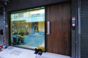 a glass door of a building with shoes in front of it at W Hostel in Tainan