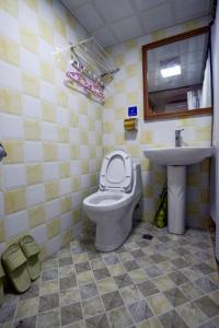 a bathroom with a toilet and a sink at Joy Style Hostel in Guilin