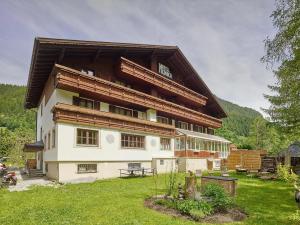 a large building in a field of green grass at Hotel Monika in Gaschurn