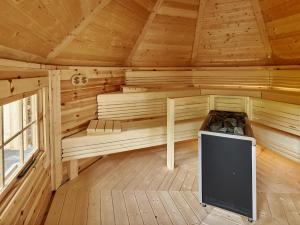 a wooden sauna with a tv in the middle at Hotel Monika in Gaschurn