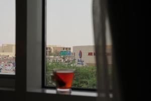 a glass of wine sitting on a window sill at Unique Suites in Riyadh