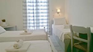 Postel nebo postele na pokoji v ubytování Hotel Faros