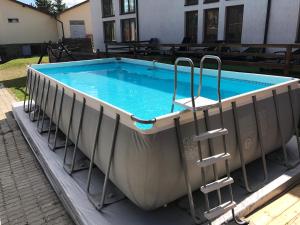 a large pool with chairs in it on a patio at Smerekova Hata in Slavske