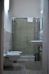 a bathroom with a shower and a toilet and a sink at Palazzo Greco Case Vacanze in Porto Cesareo