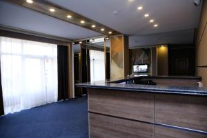 a bathroom with a counter and a large mirror at Hotel Aner in Astana