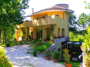 Villa Almelia في Vinchiaturo: منزل اصفر كبير امامه نباتات