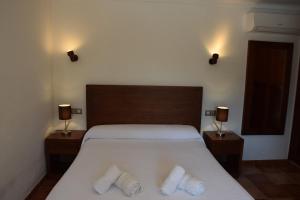 a bedroom with a bed with two pillows on it at Can La Villa in Pollença