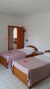 a group of three beds in a room at Delphin Apart Hotel in Side +74 photos