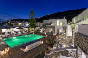 an image of a villa with a swimming pool at night at Bellissimo Resort in Agios Ioannis Mykonos
