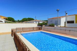 a swimming pool on the roof of a house at Costabravaforrent Ricardell in L'Escala