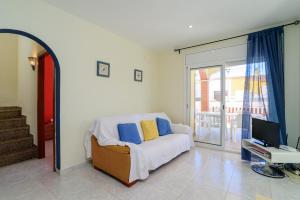 a bedroom with a bed and a desk with a computer at Costabravaforrent Ricardell in L'Escala